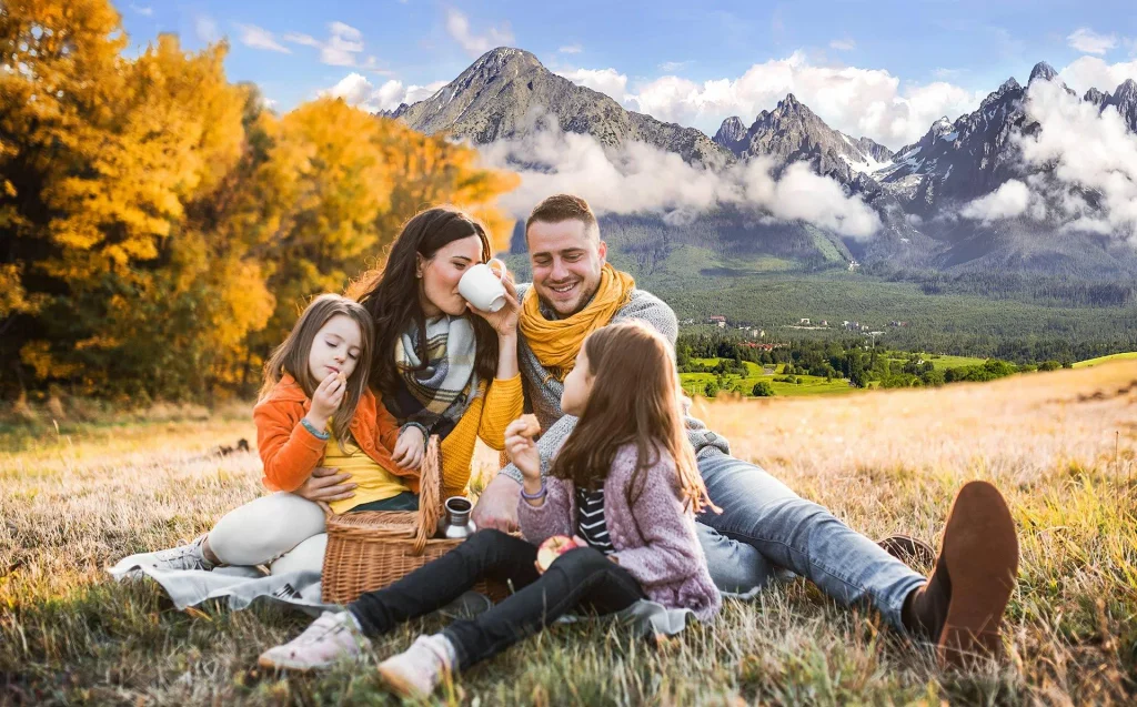 Happy October Blessings for family with a cozy autumn gathering, colorful fall scenery, pumpkins, and gratitude.