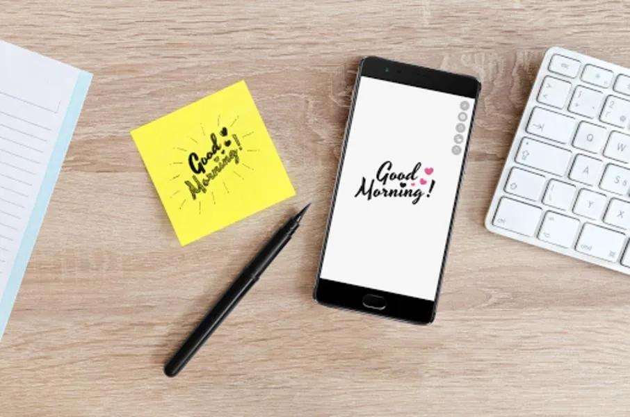 Monday morning blessings displayed on a smartphone beside coffee and flowers
