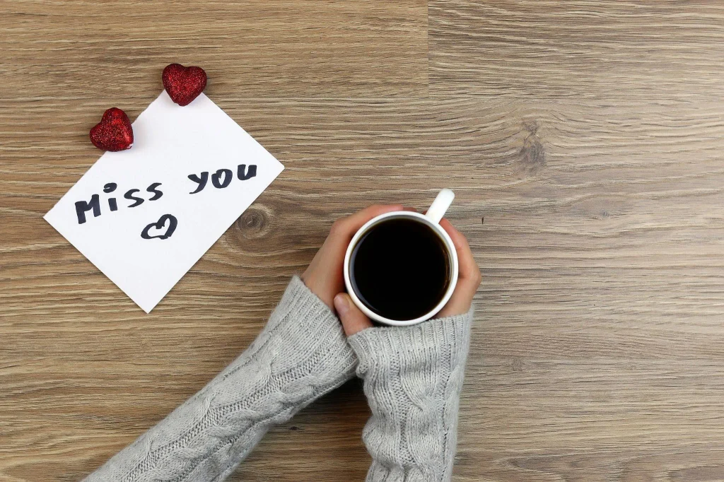 Short Miss You Messages for Boyfriend written on a romantic note beside a coffee mug